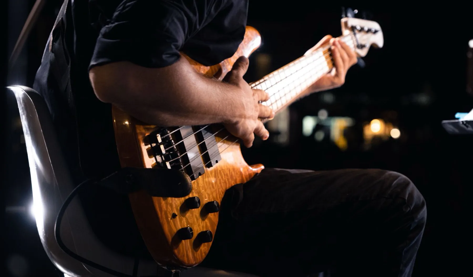 A bass player at night